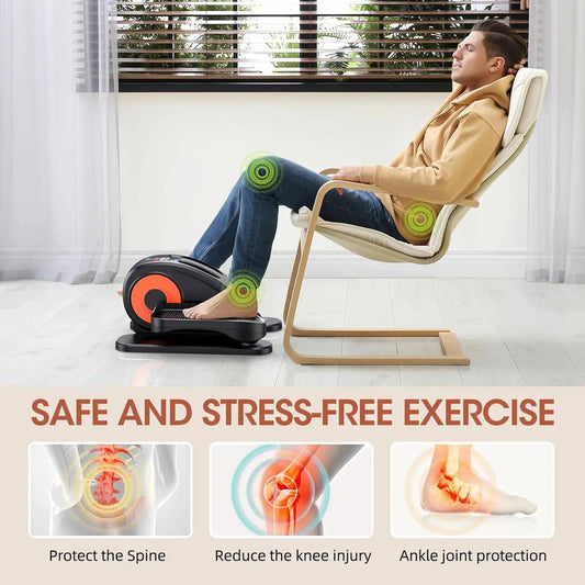 Man sitting on sofa using under desk elliptical machine leg exerciser for fitness